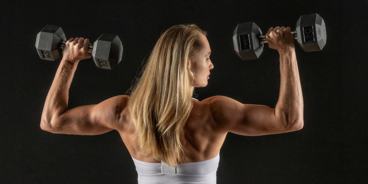 woman performing shoulder press