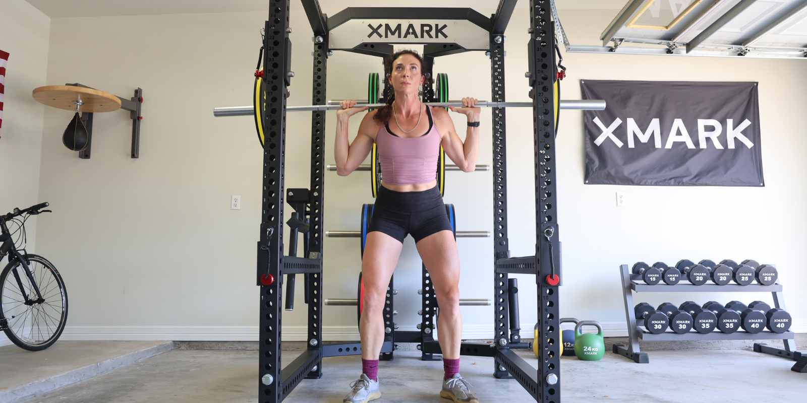 Woman in a Power Rack using a barbell