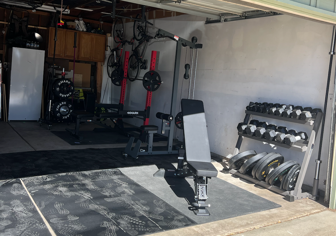 Small garage gym with bench and dumbbells