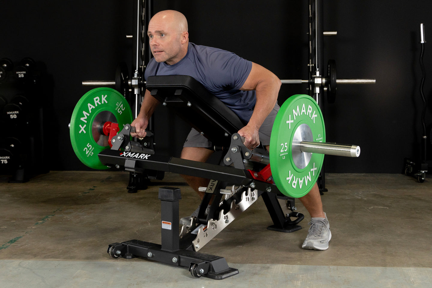 Man on weight bench performing low row with XMARK Open Hex Bar