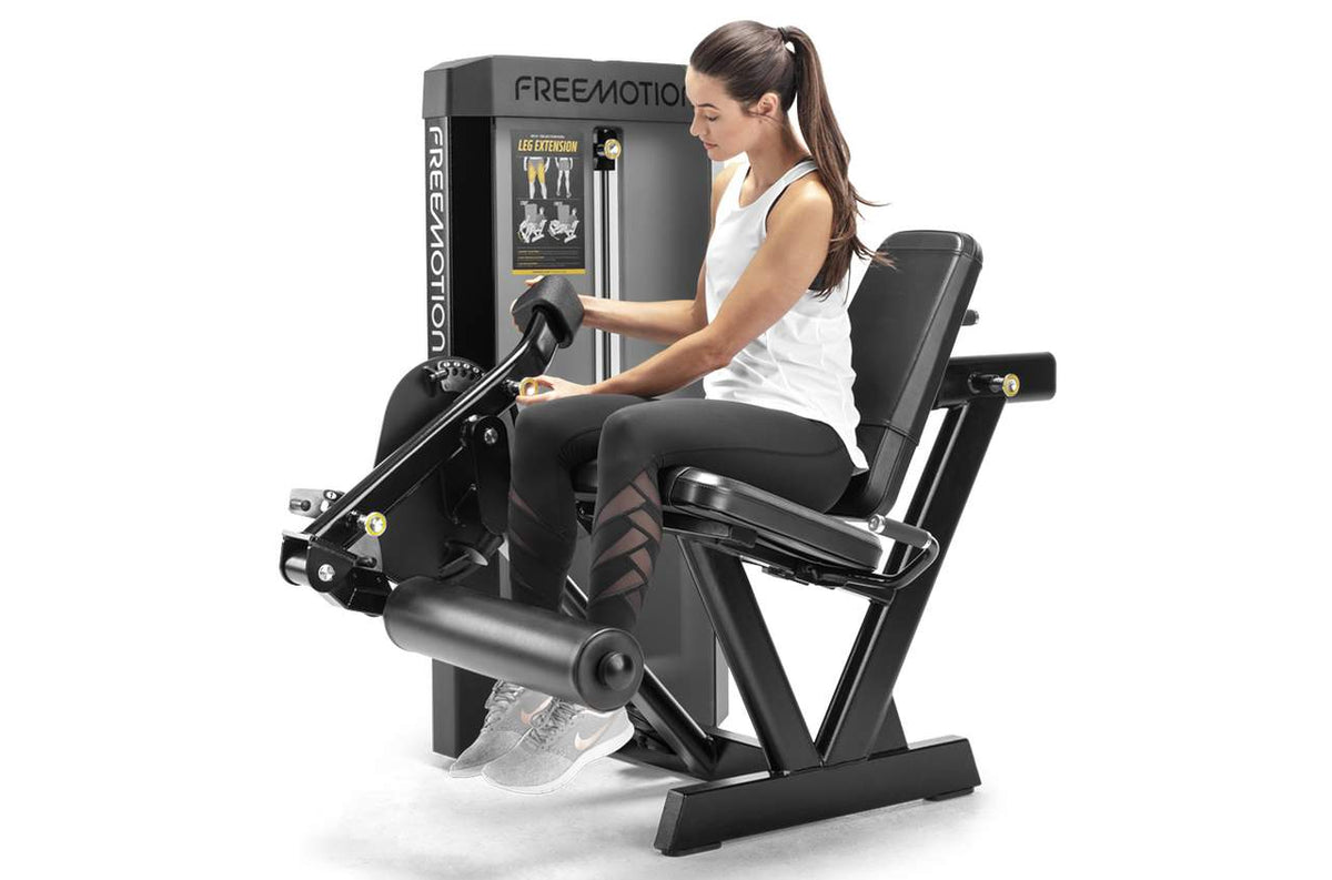 Woman working out on a FREEMOTION leg extension
