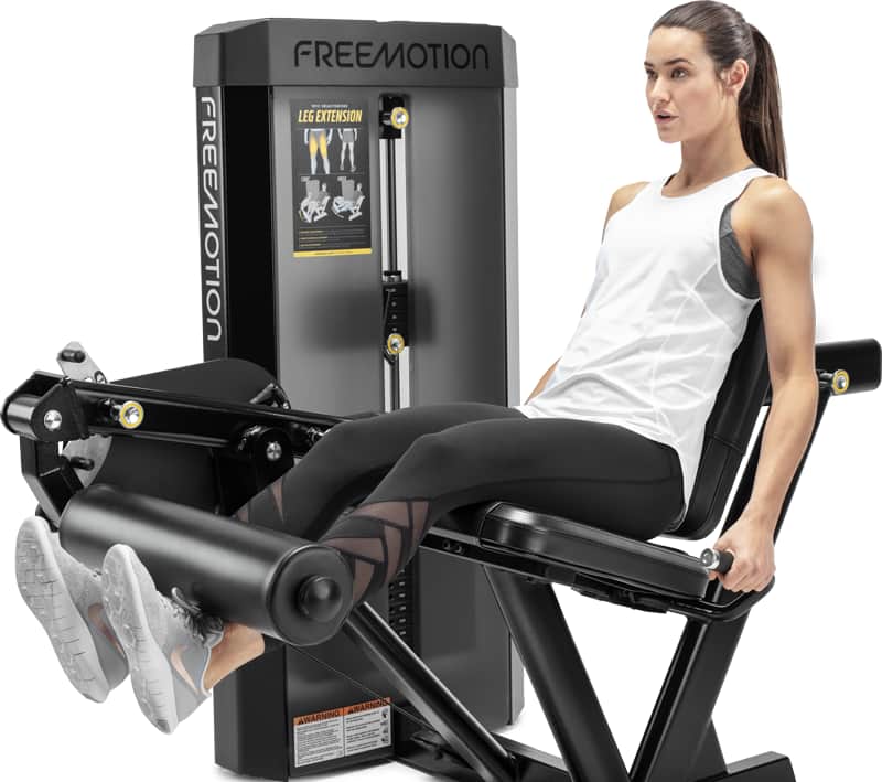 A woman exercising on a FREEMOTION leg extension.