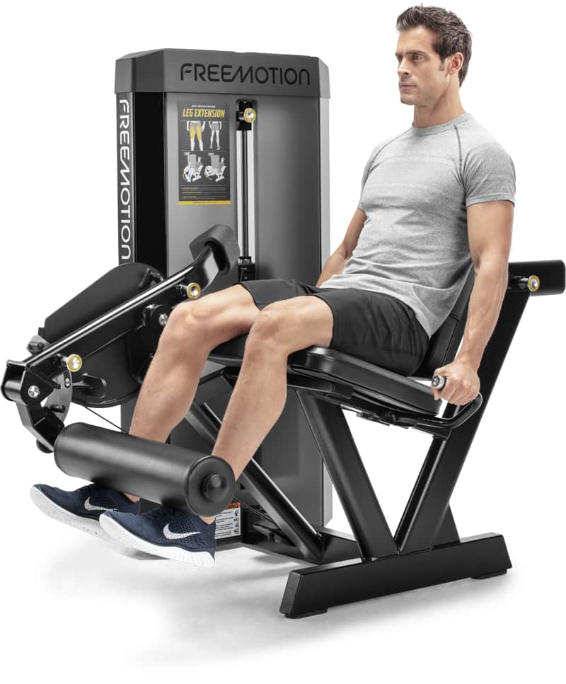 A man working out on a FREEMOTION leg extension