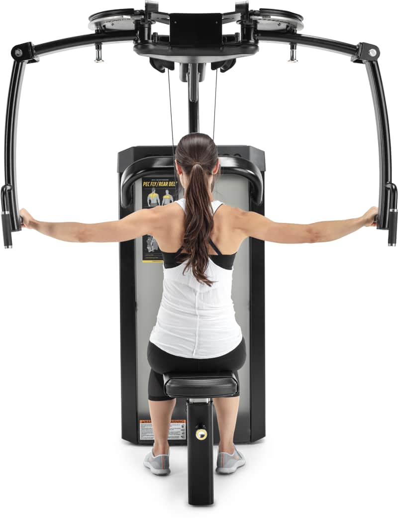 A woman viewed from behind using a back extension exercise machine, with her arms extended to the sides on a white background.