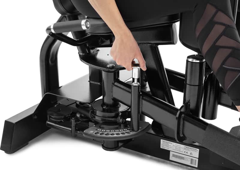 Close-up of a person's hand adjusting the range of motion on a Selectorized Hip Adduction/Abduction
