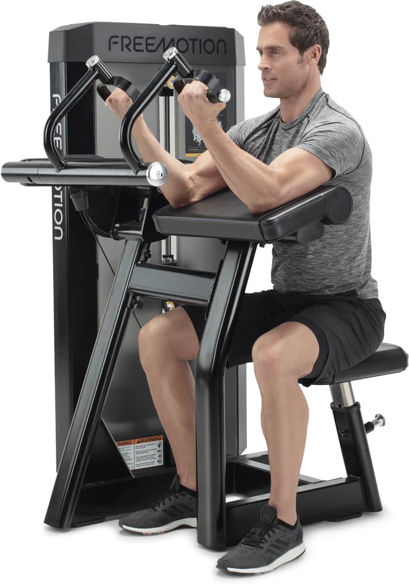 A man exercising on a Freemotion biceps curl machine
