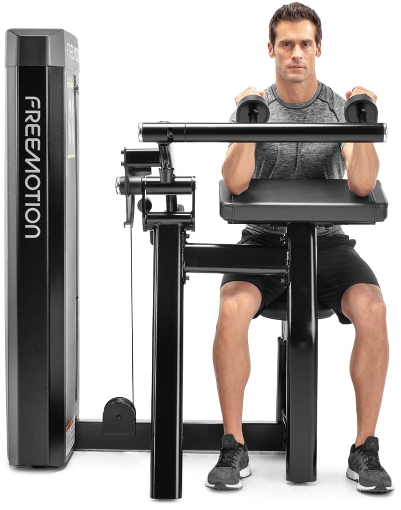 A man exercising on a  Freemotion selectorized triceps extension machine,