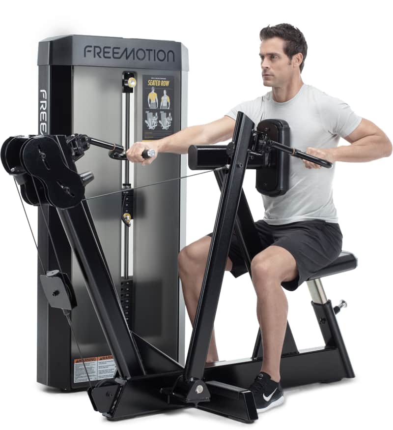 A man exercising on a A Freemotion seated row machine, side view