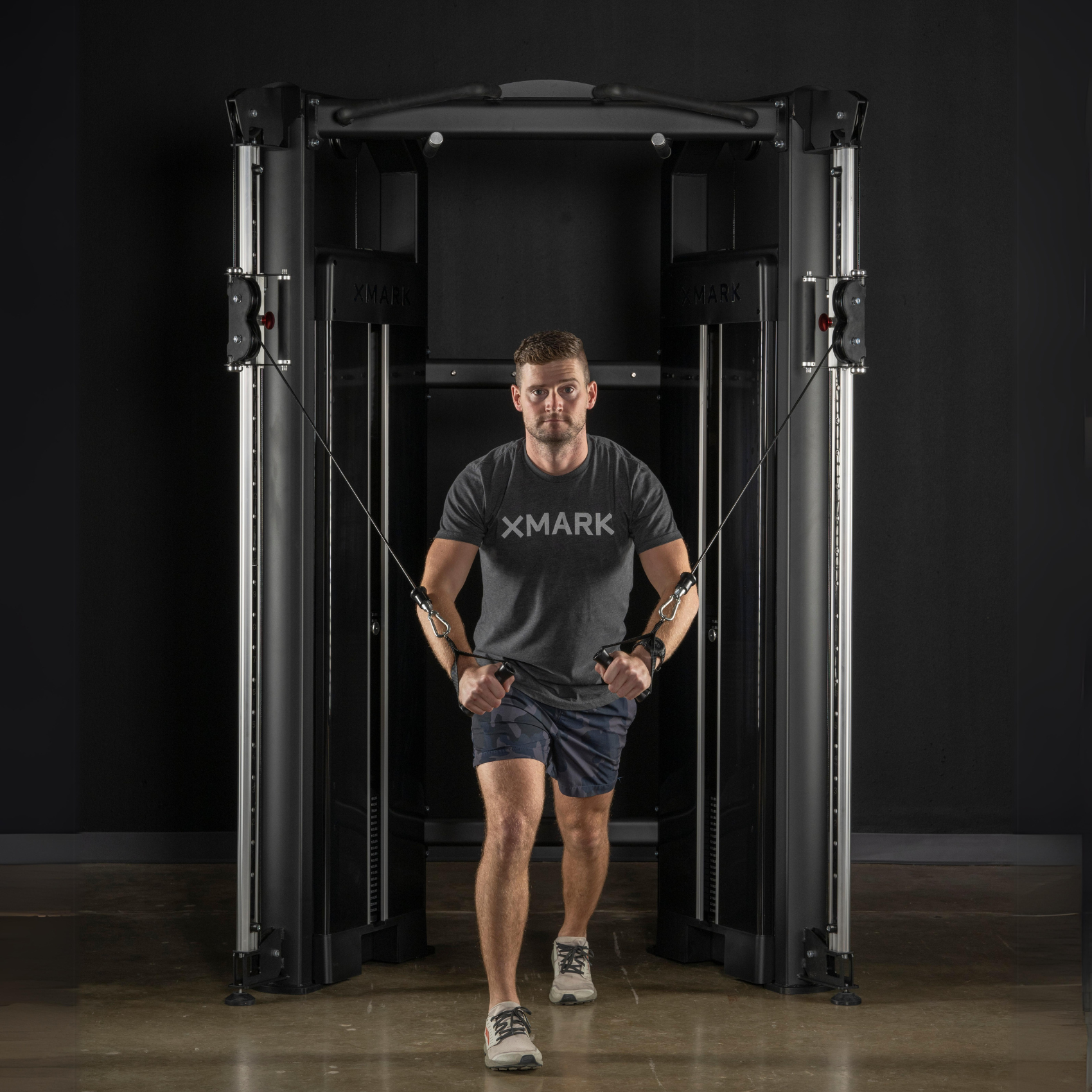 MAN USING A WHOLE-BODY FUNCTIONAL TRAINER TO WORK OUT