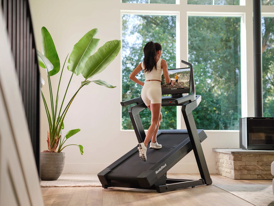 Walking uphill on the NordicTrack X24 incline treadmill at a steep 40% incline in a home gym