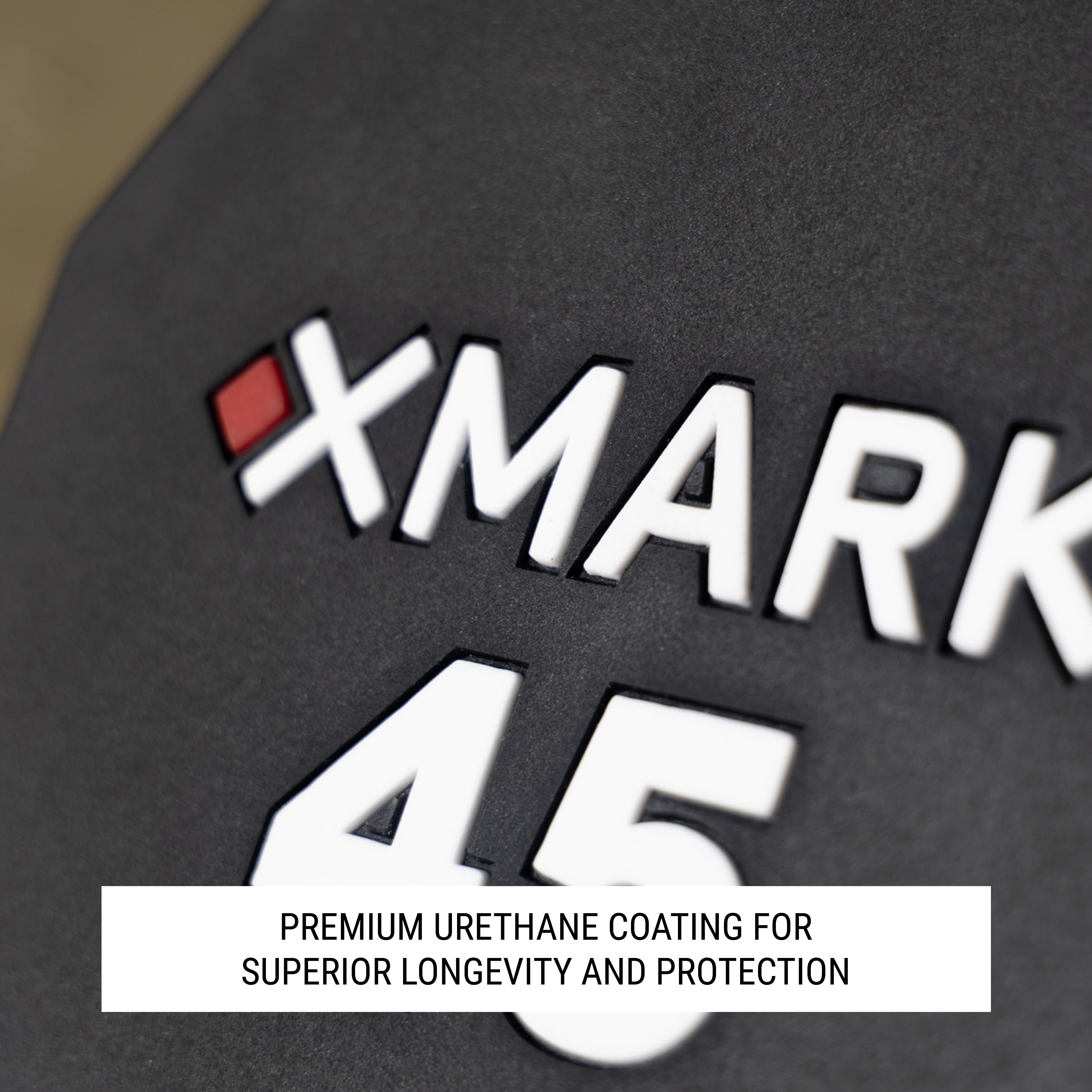 Close up of XMARK logo on head of 12-sided dumbbell