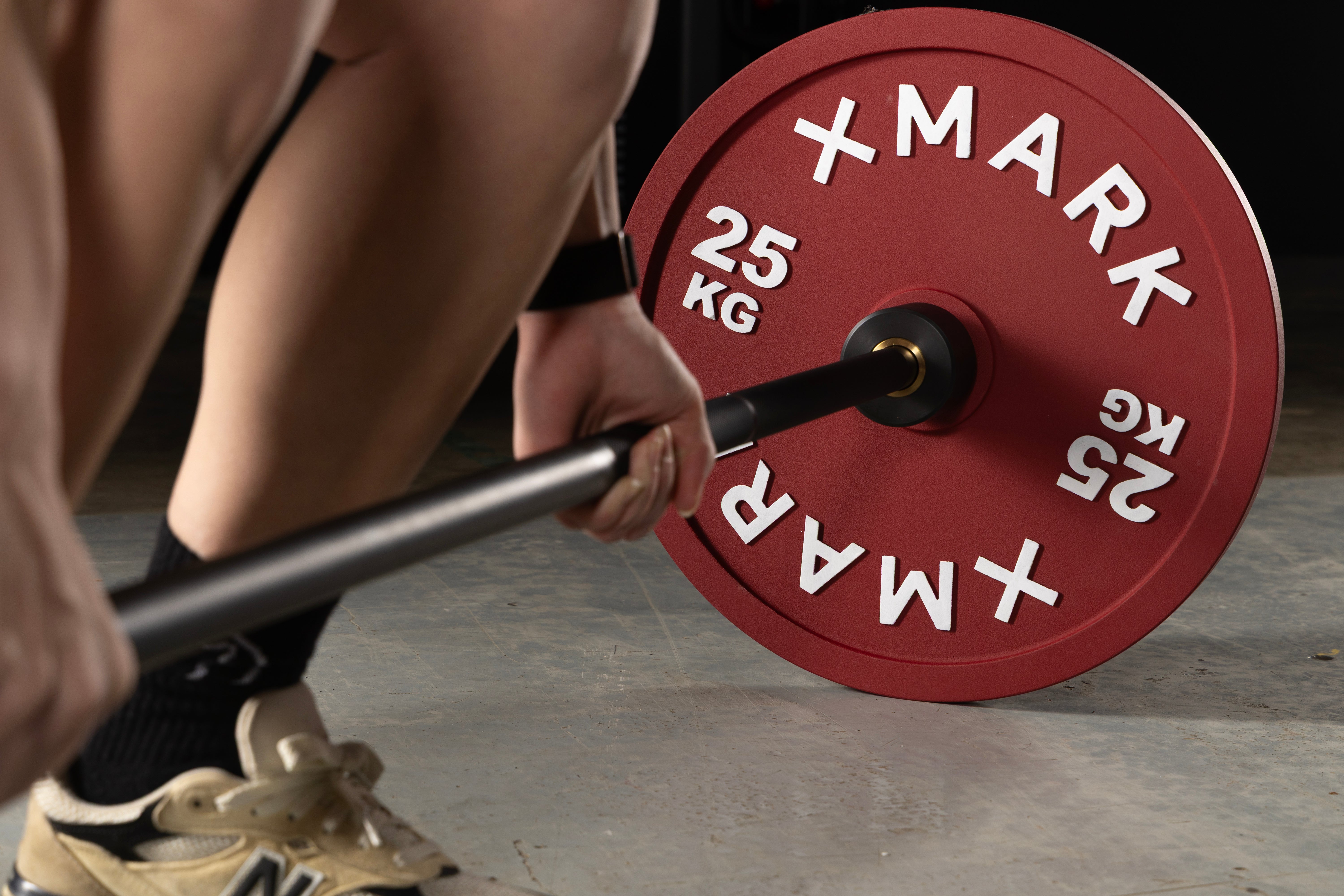 XMARK 25kg calibrated steel powerlifting plates in competition red